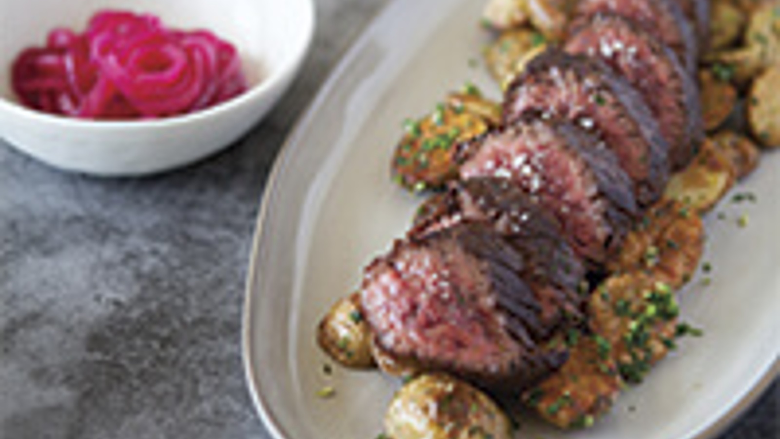 Hanger steak with roasted potatoes, gremolata and pickled red onions