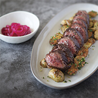 Hanger steak with roasted potatoes, gremolata and pickled red onions