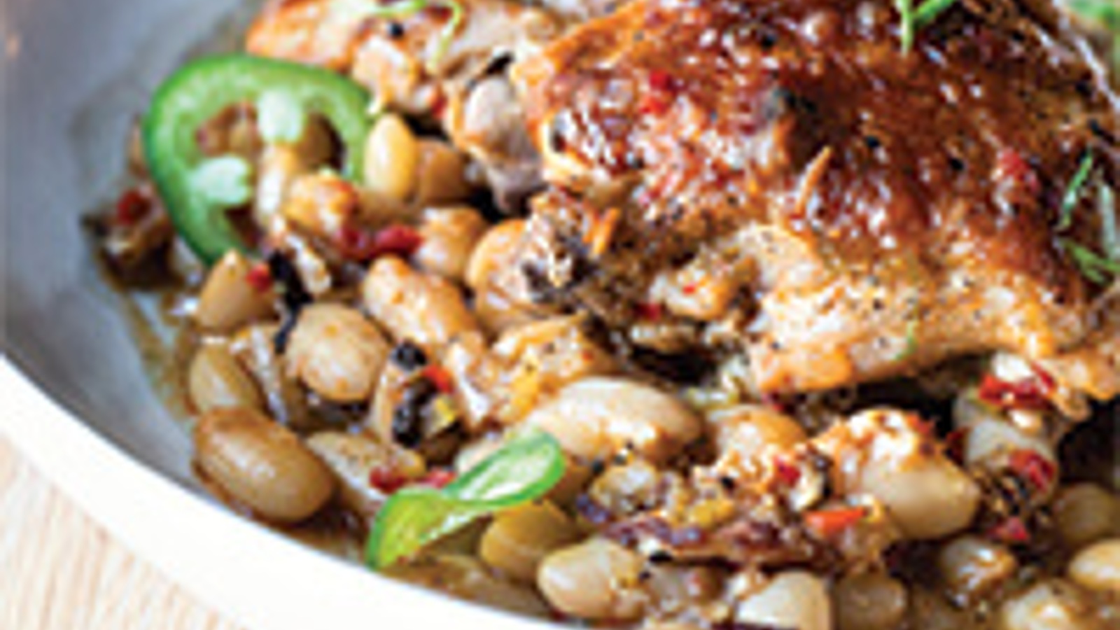 Braised chicken thighs with barbecued white beans and scallions