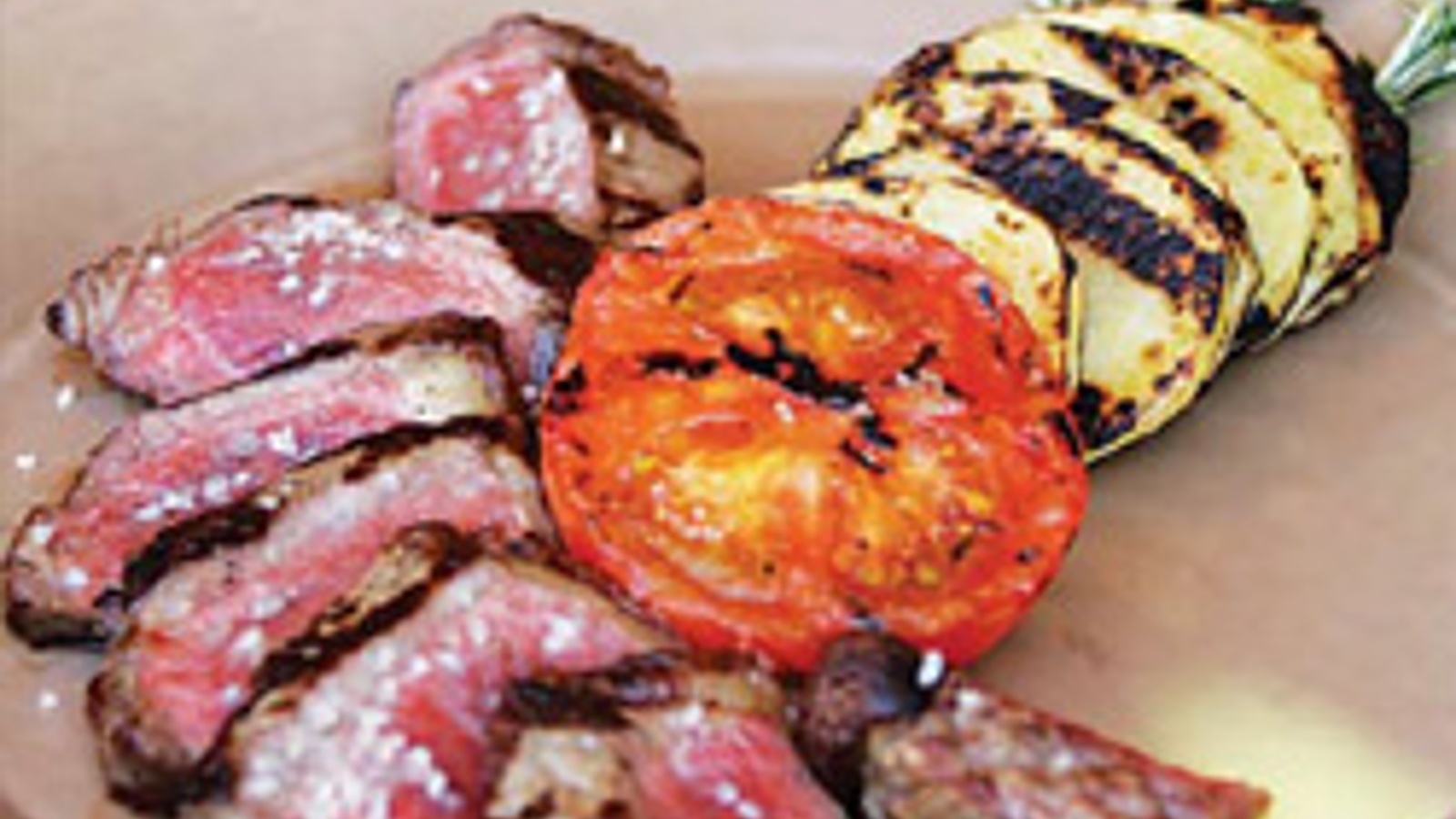 Lucky Dog Ranch New York strip steak with grilled Yukon Gold potatoes and fire-roasted tomato