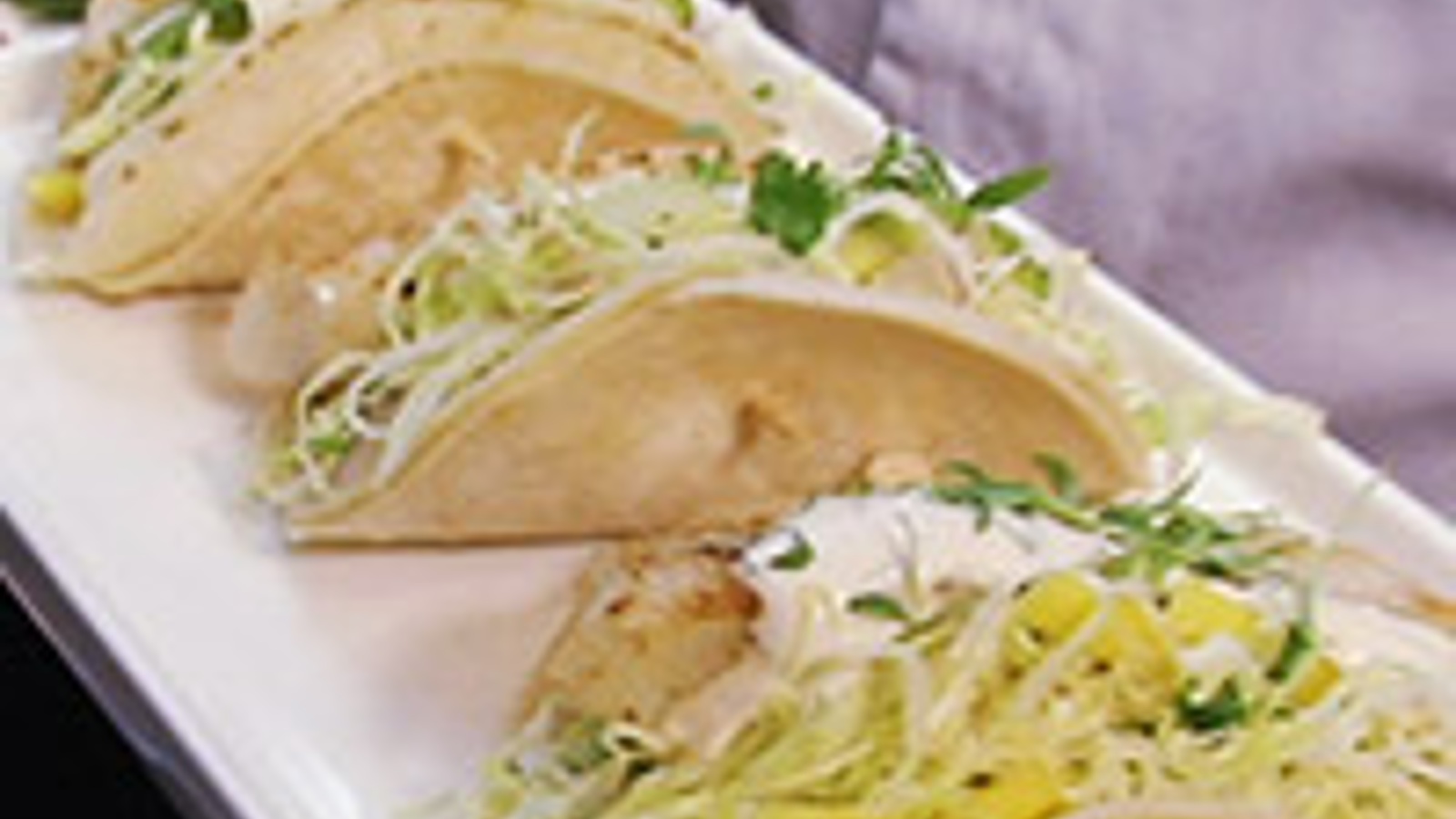 Fish tacos with avocado and mango slaw