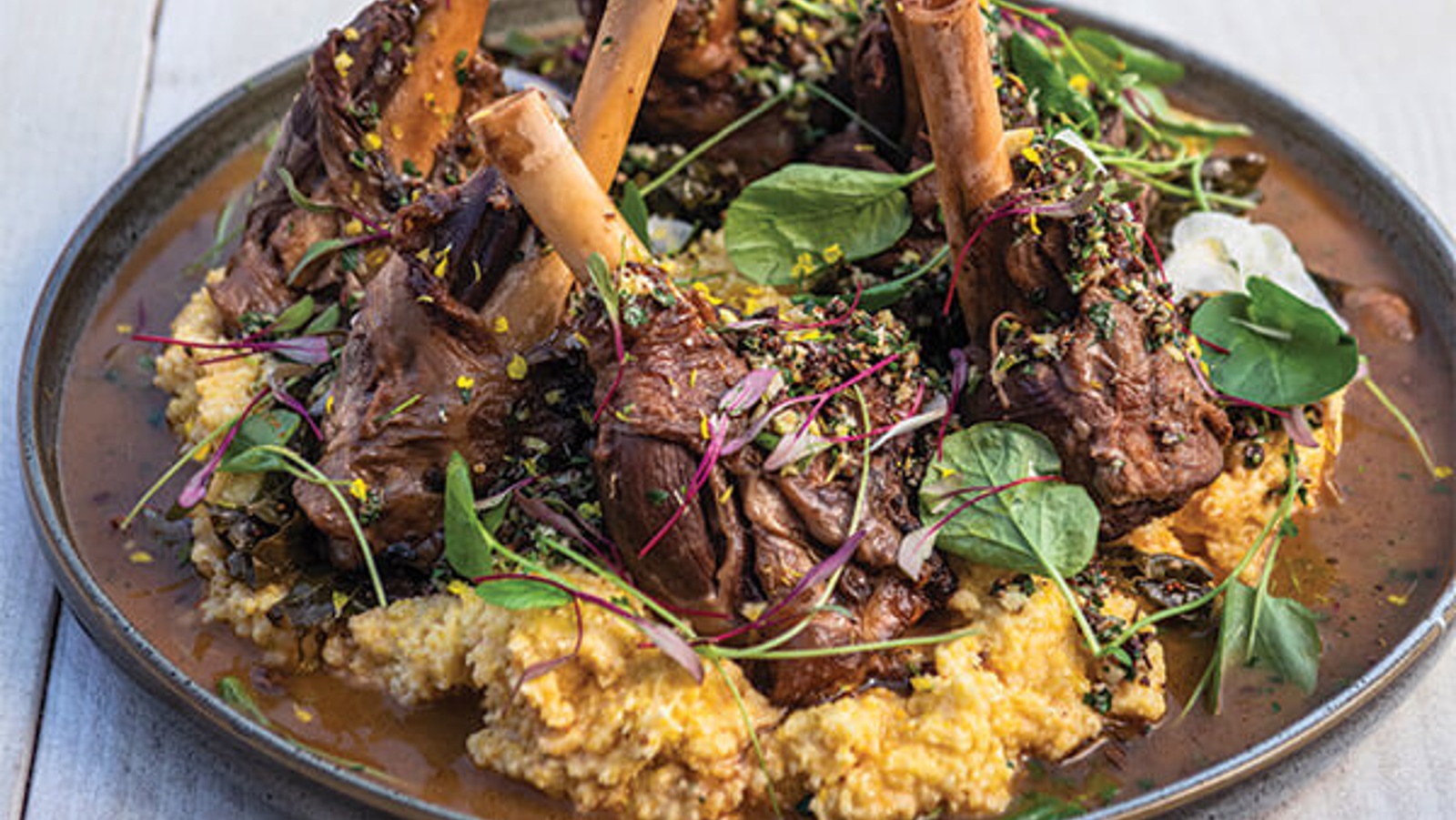 Maple bourbon braised lamb shankswith white cheddar grits and pecan horseradish gremolata