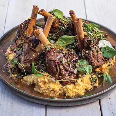 Maple bourbon braised lamb shankswith white cheddar grits and pecan horseradish gremolata