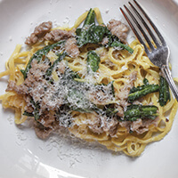 Pork sausage with dandelion greens and chili flakes