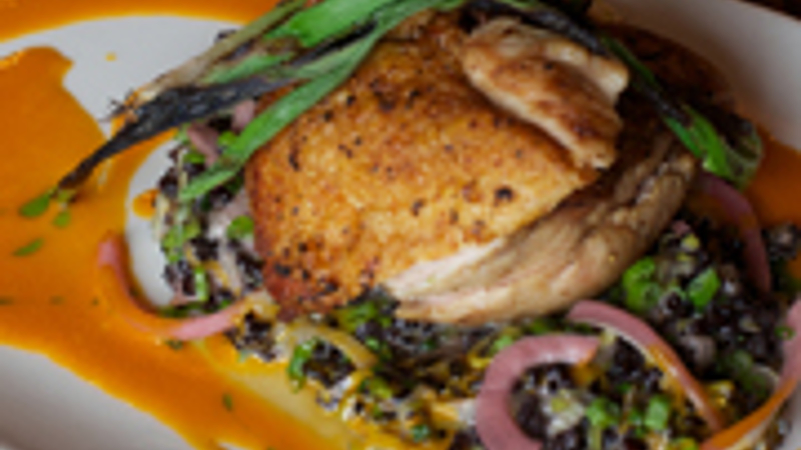 Pan roasted chicken breast with rice and sauvignon blanc-carrot reduction